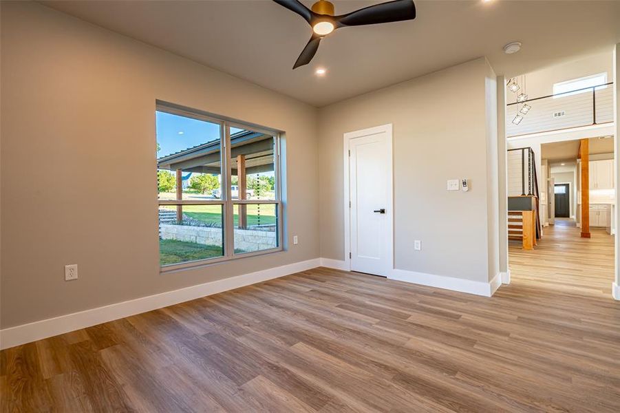 Unfurnished room with light wood-type flooring, a ceiling fan, and recessed lighting Unfurnished room with light wood-type flooring, a ceiling fan, and recessed lighting