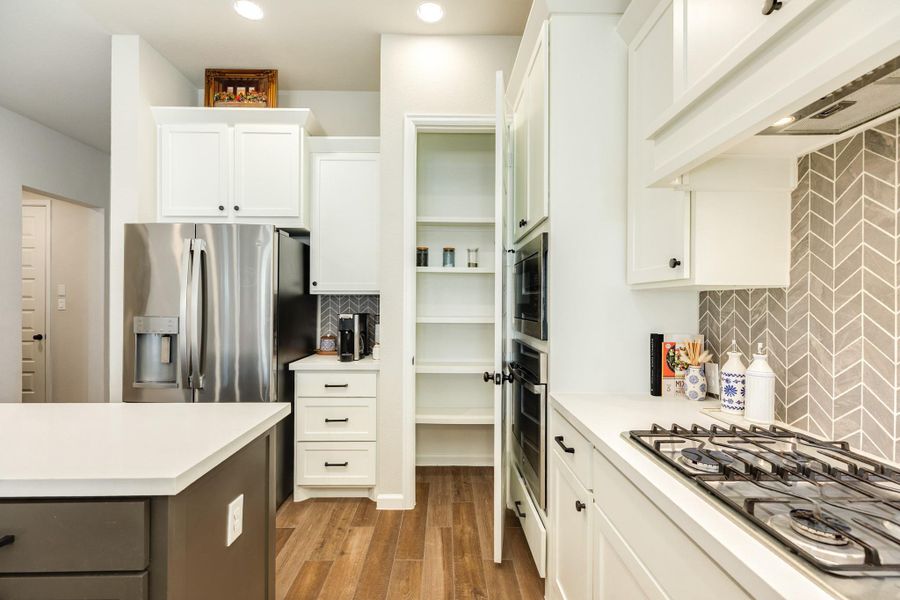 Large pantry, great backsplash, coffee bar, and stainless steel appliances. This home feels like walking into a new build. Large pantry, great backsplash, coffee bar, and stainless steel appliances. This home feels like walking into a new build.