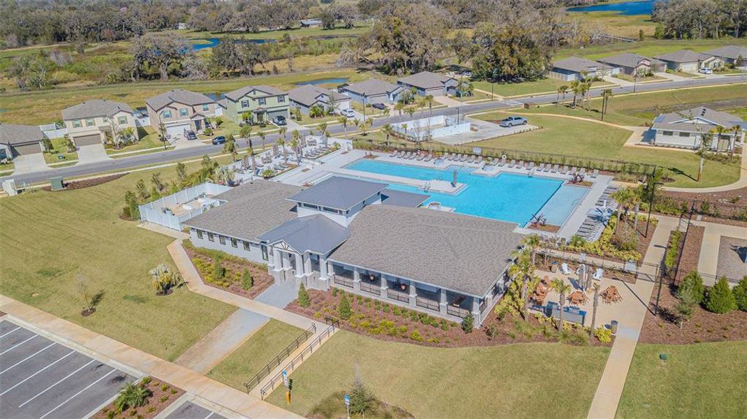 Amenity center with clubhouse, gym, and huge pool featuring sunshelf