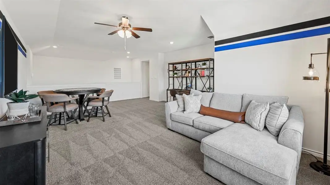 Upper-level bonus room featuring plush carpet flooring, a ceiling fan with integrated lighting, and recessed ceiling lights