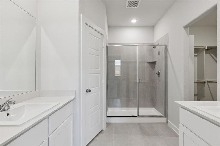 Primary Bathroom in the Cedar home plan by Trophy Signature Homes – REPRESENTATIVE PHOTO