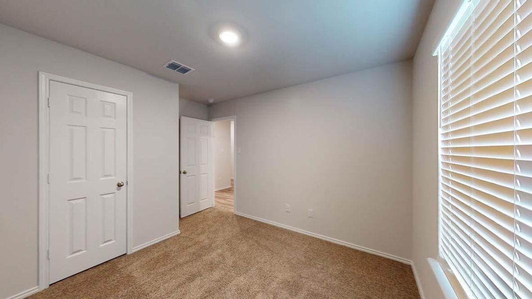 Carpeted room featuring neutral wall paint, white trim, and a window with horizontal blinds