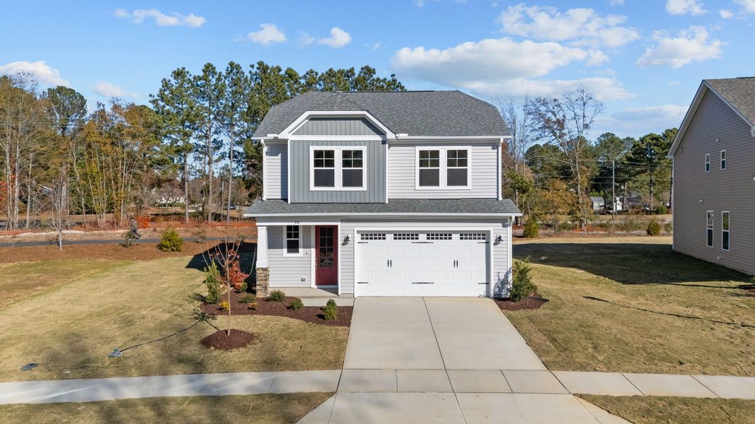Front exterior of a new home in Traditions at Carolina Forest, Myrtle Beach, SC, highlighting curb appeal (Image 2). Front exterior of a new home in Traditions at Carolina Forest, Myrtle Beach, SC, highlighting curb appeal (Image 2).
