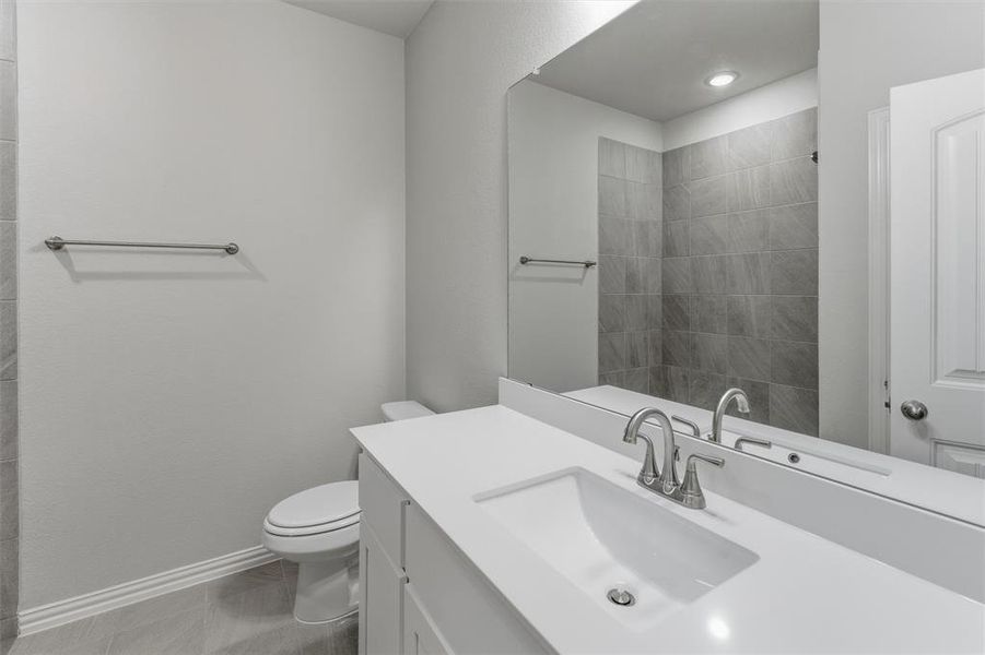 Full bath featuring vanity and light tile patterned floors