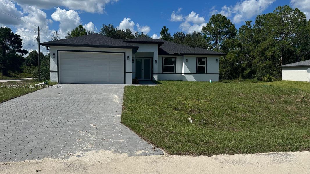 Front exterior of a new home in , Lehigh Acres, FL, highlighting curb appeal (Image 2). Front exterior of a new home in , Lehigh Acres, FL, highlighting curb appeal (Image 2).