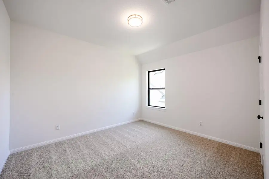 Empty room featuring carpet floors, baseboards, and vaulted ceiling Empty room featuring carpet floors, baseboards, and vaulted ceiling