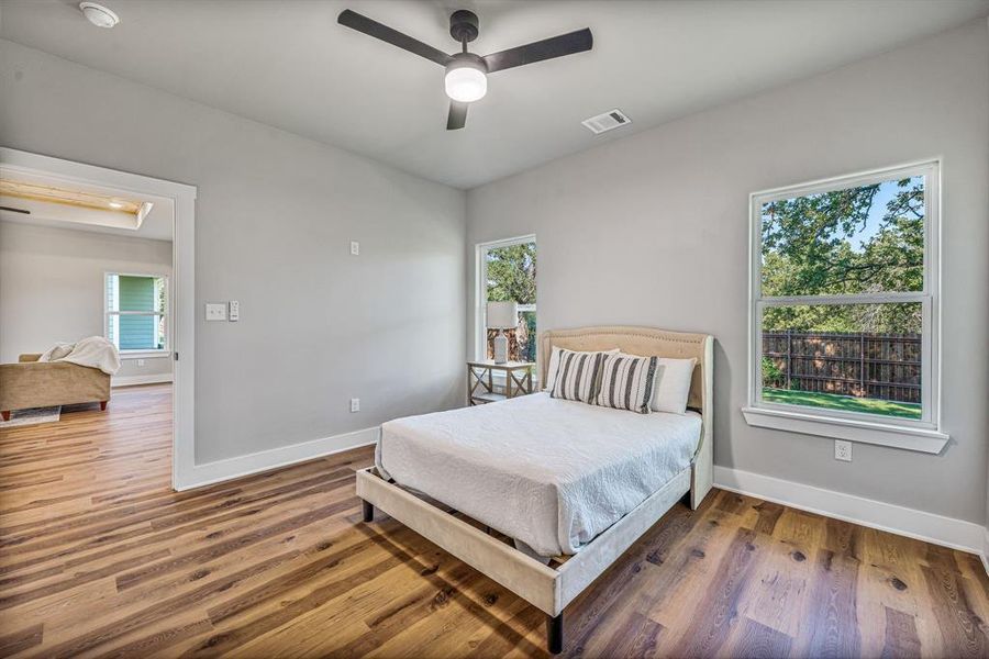 Bedroom with wood finished floors and a ceiling fan Bedroom with wood finished floors and a ceiling fan