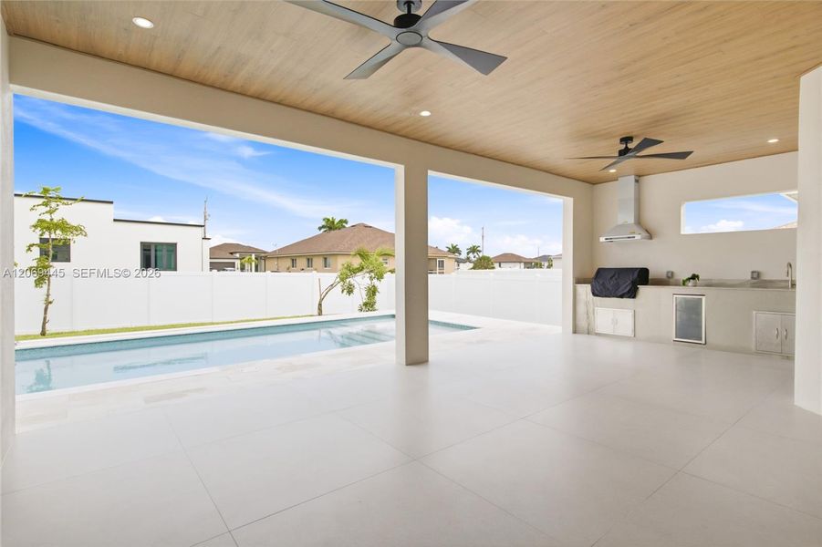 Outside oasis w/ expansive covered lanai showcasing a beautiful flat wood ceiling Outside oasis w/ expansive covered lanai showcasing a beautiful flat wood ceiling