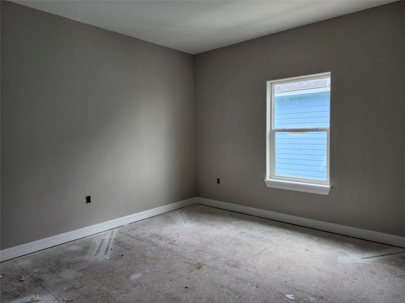 This photo shows a bedroom with neutral painted walls.