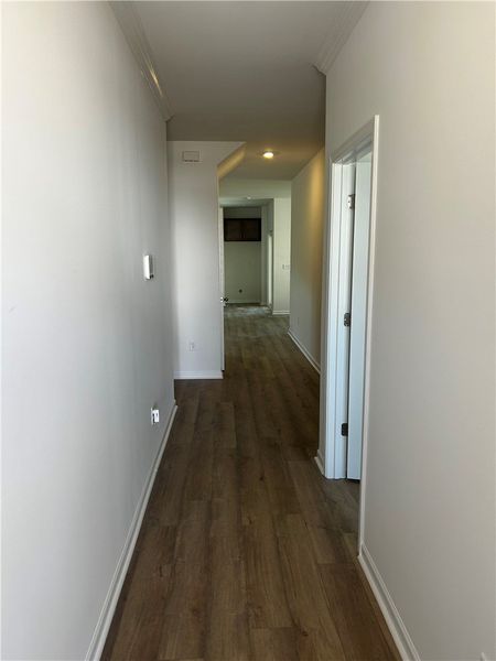 This interior hallway features sleek hardwood floo