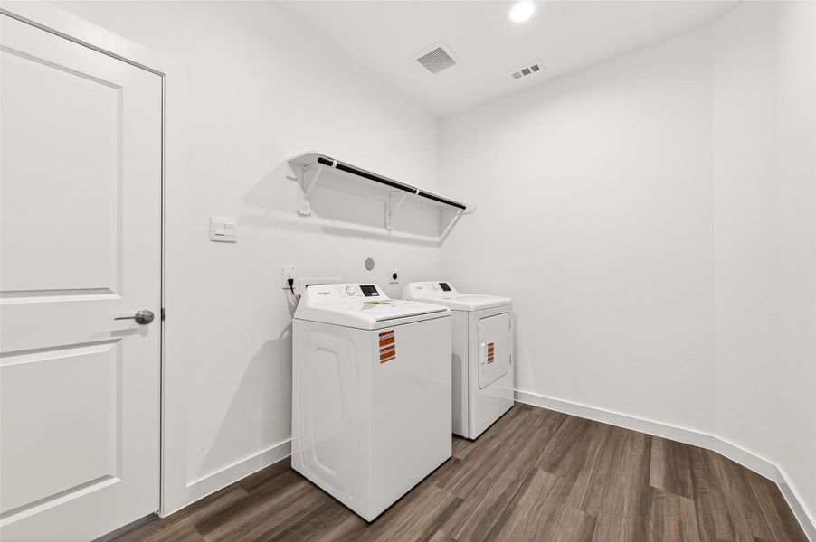 Downstairs Laundry Room: Additional highlights include a large laundry room with hanging rods and shelving!