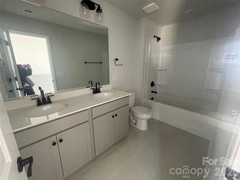 Upstairs secondary bathroom with DUAL sinks and linen closet