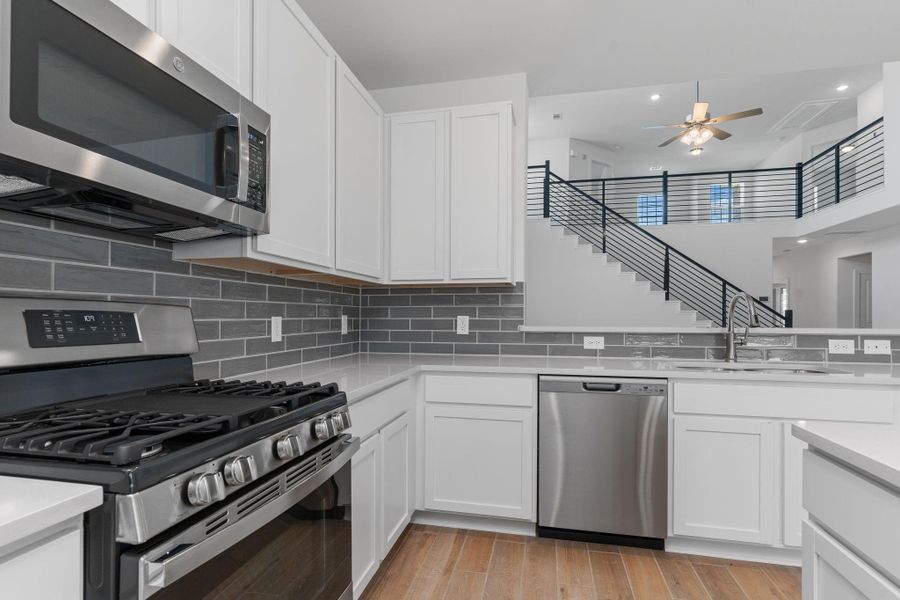 Cook and create in a space that’s as stylish as it is functional! The kitchen boasts gleaming stainless-steel appliances, a beautiful glass subway tile backsplash, and soft-close cabinets—all designed with the modern homeowner in mind. Cook and create in a space that’s as stylish as it is functional! The kitchen boasts gleaming stainless-steel appliances, a beautiful glass subway tile backsplash, and soft-close cabinets—all designed with the modern homeowner in mind.