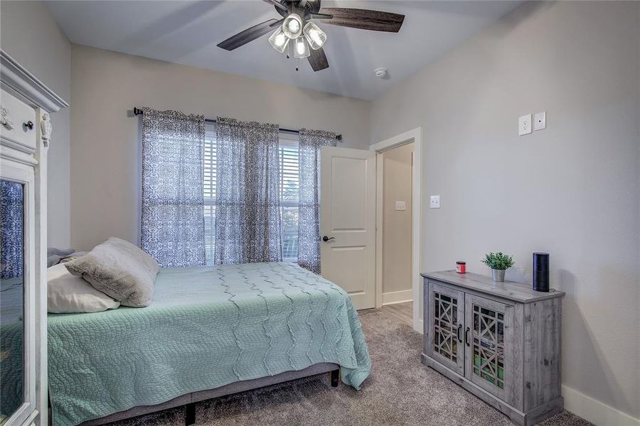 Bedroom with carpet flooring and ceiling fan