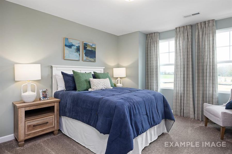 Bedroom featuring dark colored carpet