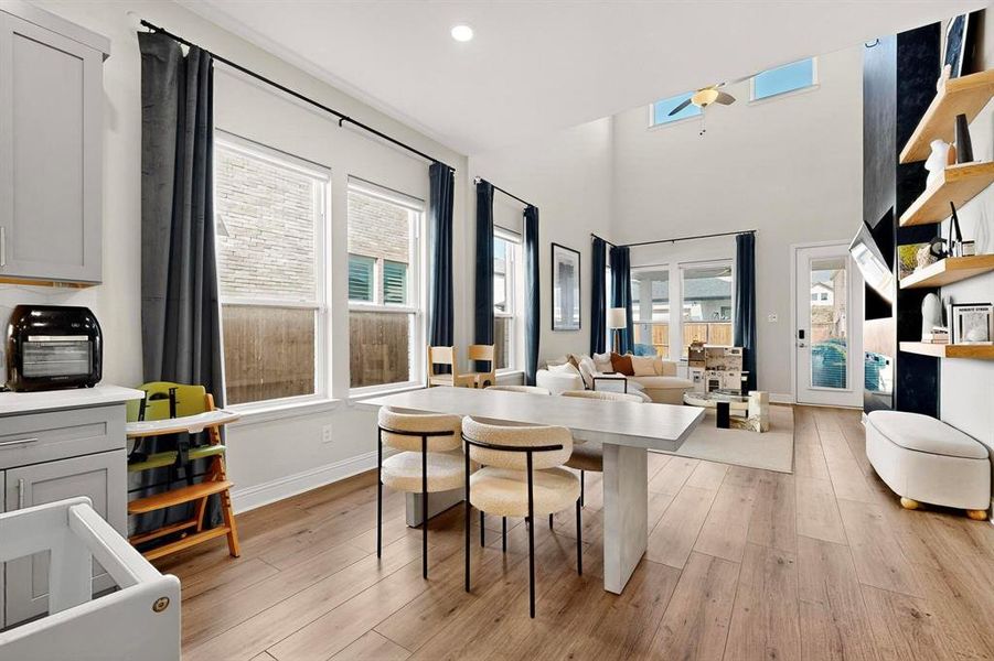 Dining room with healthy amount of natural light, light wood-style floors, a skylight, and recessed lighting Dining room with healthy amount of natural light, light wood-style floors, a skylight, and recessed lighting