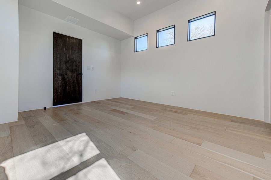 master bedroom featuring light wood finished floors, visible vents, and recessed lighting