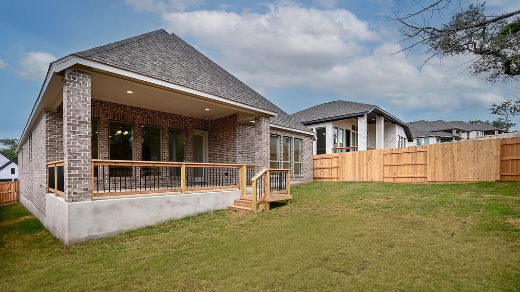 Back of house featuring brick siding and roof with shingles Back of house featuring brick siding and roof with shingles
