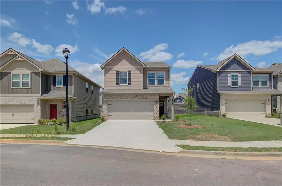 Front exterior of a new home in Towne Center, Hampton, GA, highlighting curb appeal (Image 1). Front exterior of a new home in Towne Center, Hampton, GA, highlighting curb appeal (Image 1).