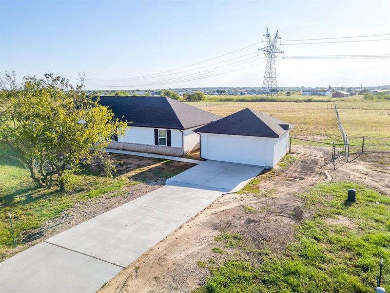View of front of home with a garage and driveway