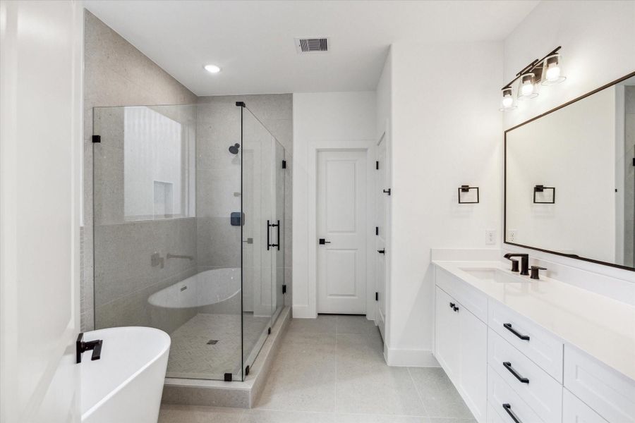 Relax and unwind in this spacious ceramic tub, complemented by sleek, modern wall tiles. Relax and unwind in this spacious ceramic tub, complemented by sleek, modern wall tiles.