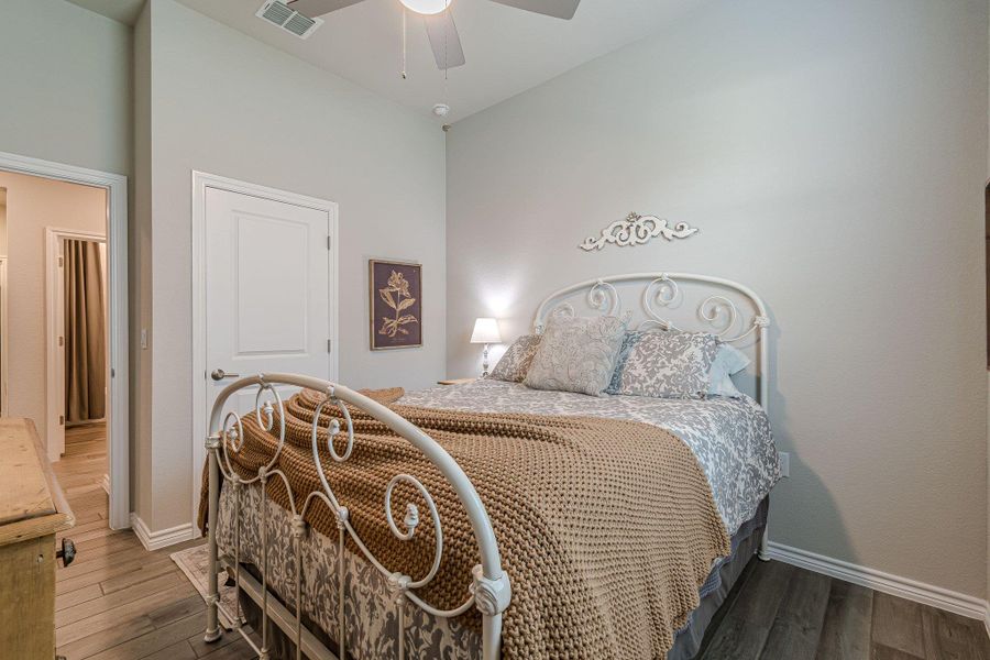 Bedroom with wood finished floors, baseboards, and ceiling fan