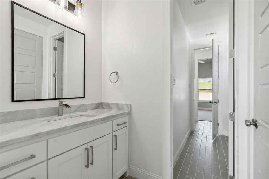 Bathroom featuring vanity and tile patterned floors