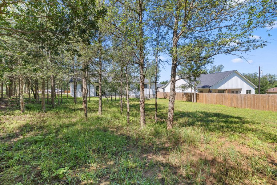A spacious yard with mature trees provides ample green space and privacy for this contemporary residence. A spacious yard with mature trees provides ample green space and privacy for this contemporary residence.