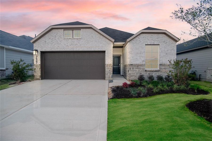 Stunning brick and stone exterior with great curb appeal and charm (Grass virtually enhanced)