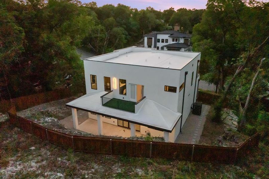 Back of house featuring a fenced backyard, a patio, and stucco siding