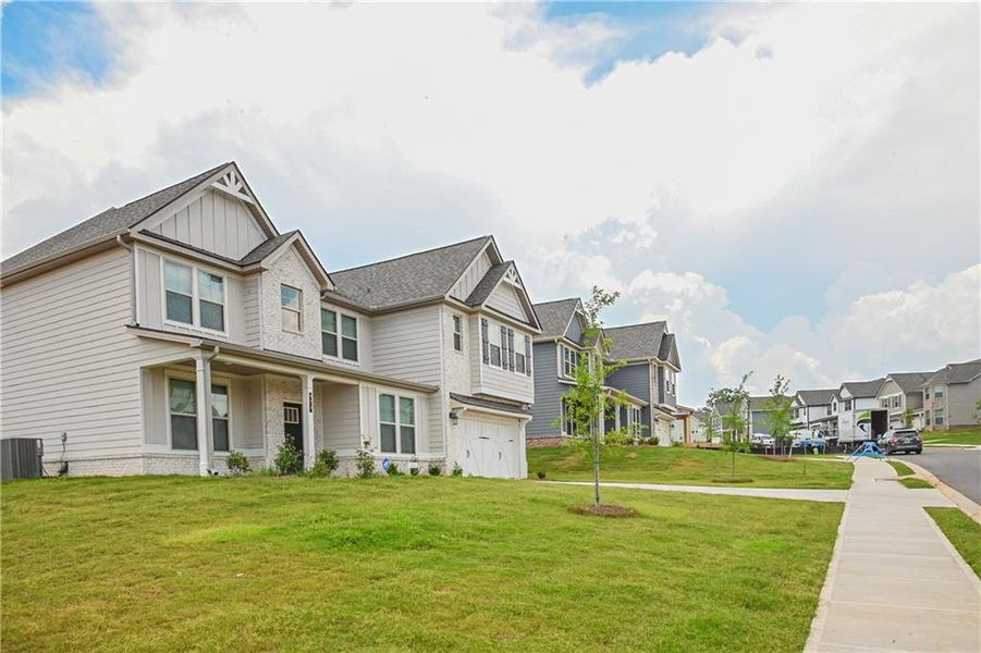 Front exterior of a new home in , Stockbridge, GA, highlighting curb appeal (Image 35).