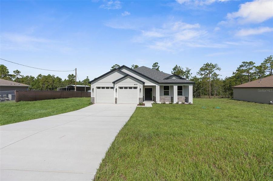Front exterior of a new home in , Weeki Wachee, FL, highlighting curb appeal (Image 28).