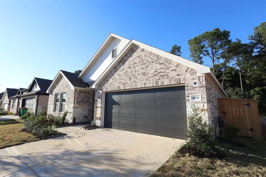 Front exterior of a new home in Sorella, Tomball, TX, highlighting curb appeal (Image 1).