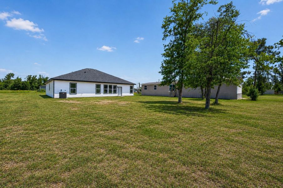 Spacious backyard with endless possibilities for outdoor entertaining, play areas, gardening, or future customization.