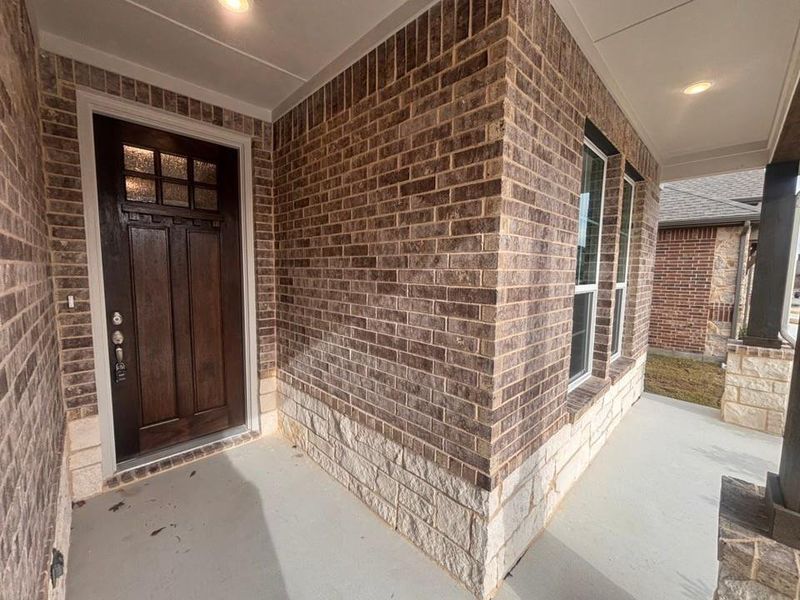 View of exterior entry with a porch and brick siding View of exterior entry with a porch and brick siding