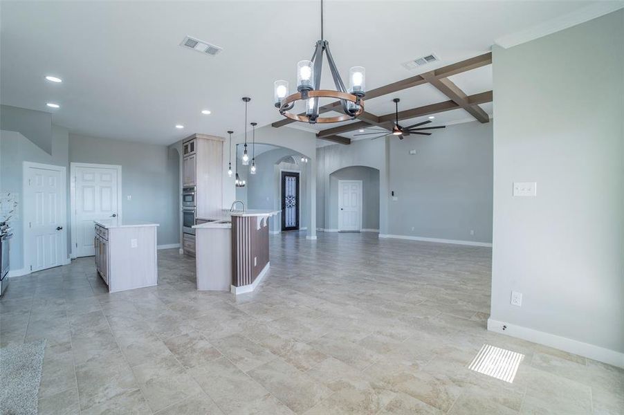 Kitchen with coffered ceiling, a chandelier, arched walkways, a center island, and pendant lighting Kitchen with coffered ceiling, a chandelier, arched walkways, a center island, and pendant lighting