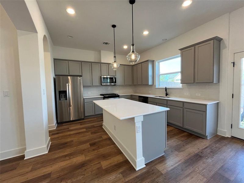 Upgraded sparkling quartz countertops. 42" painted cabinets with crown molding. Pendant lighting. 5" baseboards and picture window.