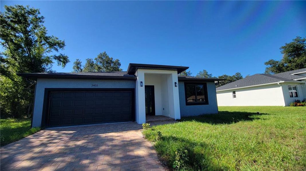 Front exterior of a new home in , North Port, FL, highlighting curb appeal (Image 2). Front exterior of a new home in , North Port, FL, highlighting curb appeal (Image 2).