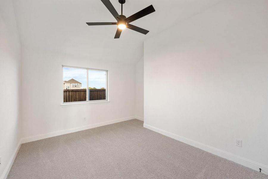 Empty bedroom with white walls, gray carpet, ceiling fan, and single window Empty bedroom with white walls, gray carpet, ceiling fan, and single window