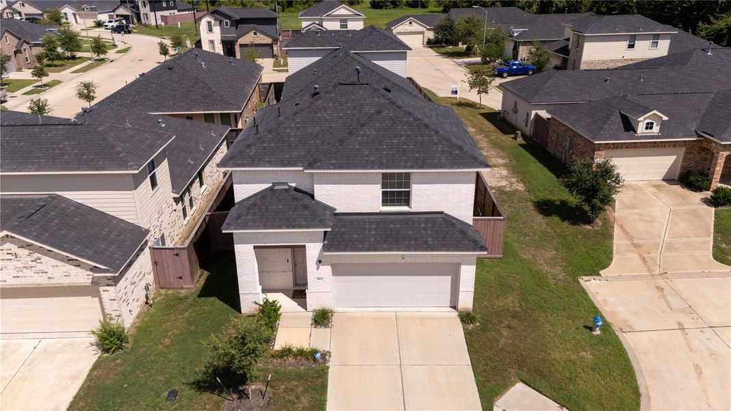 Front exterior of a new home in Woodshore, Clute, TX, highlighting curb appeal (Image 23).