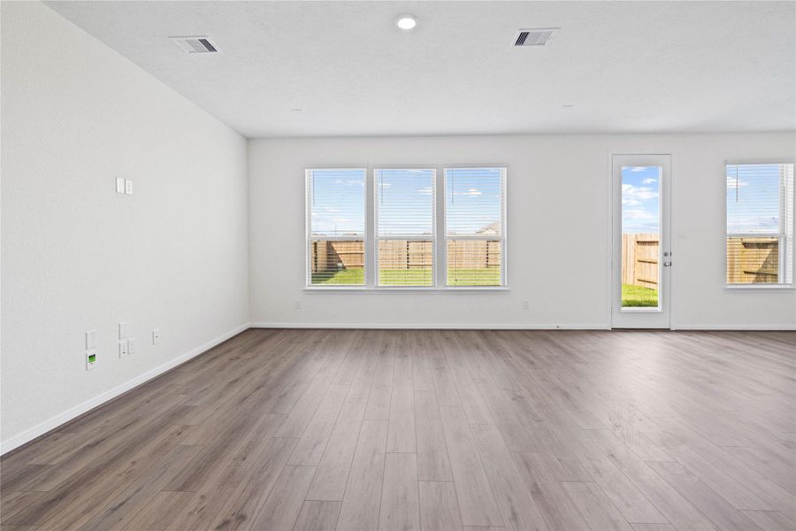 This bright and airy Great Room offers a spacious layout ideal for both relaxing evenings and lively gatherings. Designed for comfort and connection, it features Layton Lake vinyl plank flooring in Wild Dunes, large windows with blinds, high ceilings, recessed lighting, and seamless access to the stunning kitchen and dining—perfect for everyday living and entertaining alike. This bright and airy Great Room offers a spacious layout ideal for both relaxing evenings and lively gatherings. Designed for comfort and connection, it features Layton Lake vinyl plank flooring in Wild Dunes, large windows with blinds, high ceilings, recessed lighting, and seamless access to the stunning kitchen and dining—perfect for everyday living and entertaining alike.