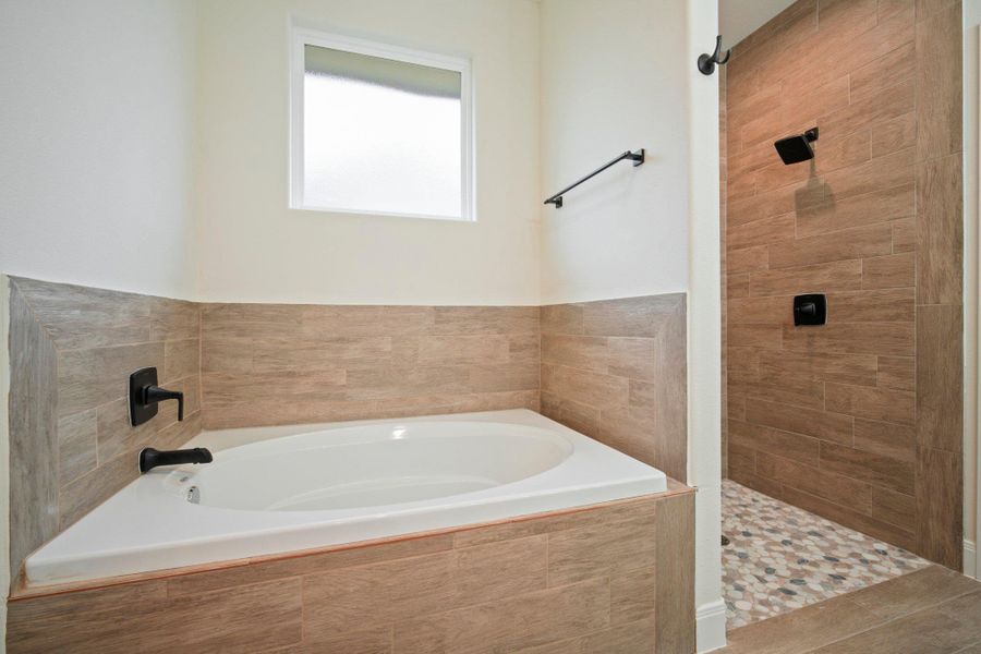 Full bath with a garden tub and a tile shower