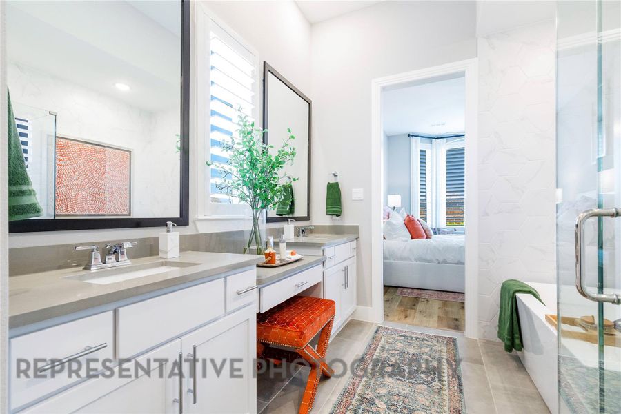 Ensuite bathroom featuring double vanity and light tile patterned flooring Ensuite bathroom featuring double vanity and light tile patterned flooring