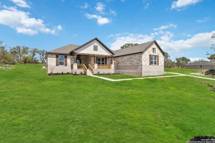 Front exterior of a new home in Jordan's Ranch, San Antonio, TX, highlighting curb appeal (Image 1). Front exterior of a new home in Jordan's Ranch, San Antonio, TX, highlighting curb appeal (Image 1).