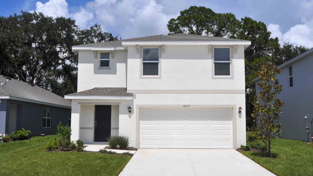 Front exterior of a new home in Oakfield Lakes, Parrish, FL, highlighting curb appeal (Image 1). Front exterior of a new home in Oakfield Lakes, Parrish, FL, highlighting curb appeal (Image 1).