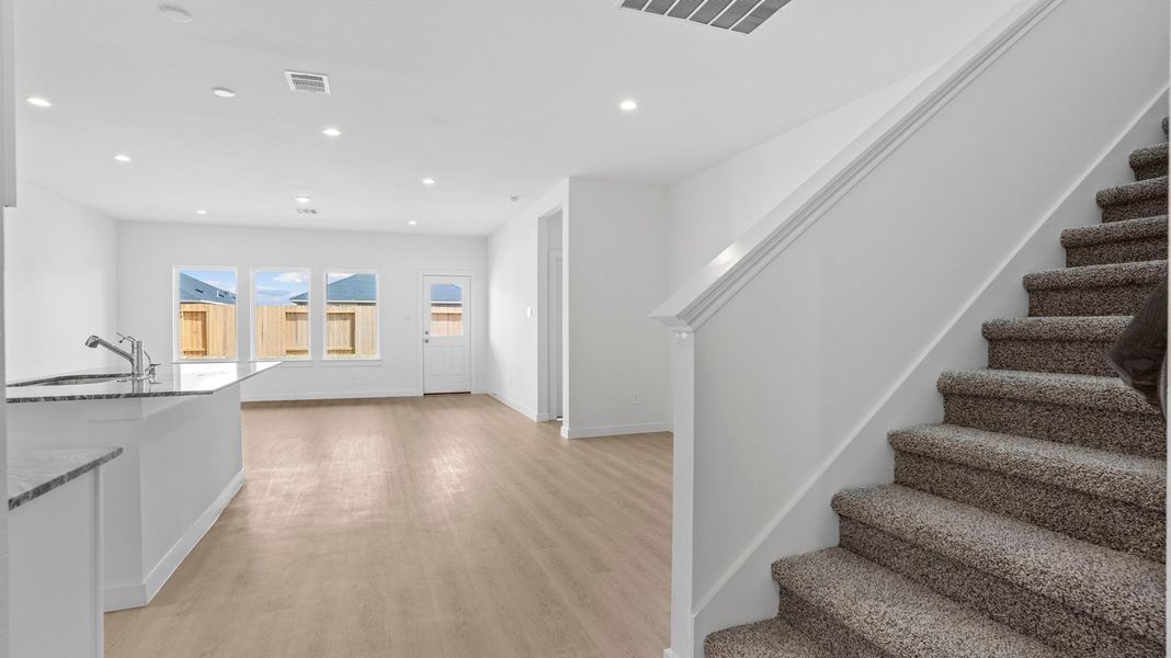 Representative unfurnished interior of a home built from the Mitchell by D.R. Horton in Caldwell Crossing, Iowa Colony (Image 14).
