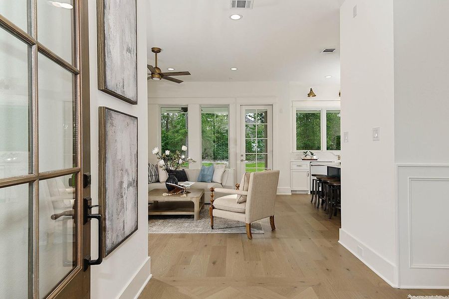 Step inside and notice the inviting designer color palette, premium finishes, and sight line to windows and glorious trees.