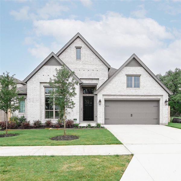 Front exterior of a new home in La Cima, San Marcos, TX, highlighting curb appeal (Image 14). Front exterior of a new home in La Cima, San Marcos, TX, highlighting curb appeal (Image 14).