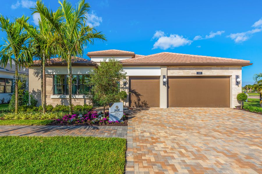 Front exterior of a new home in Valencia Del Mar (55+), Boynton Beach, FL, highlighting curb appeal (Image 1). Front exterior of a new home in Valencia Del Mar (55+), Boynton Beach, FL, highlighting curb appeal (Image 1).
