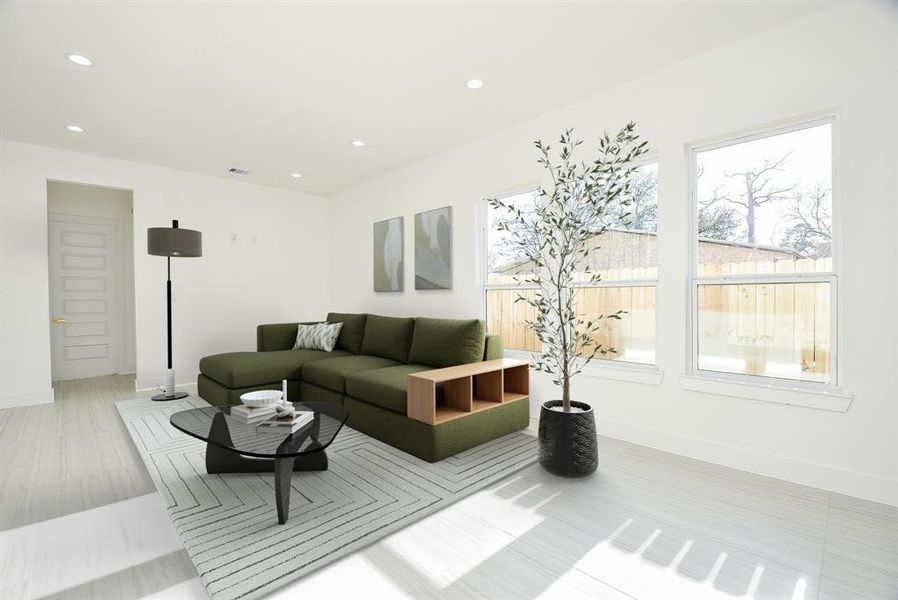 This spacious yet cozy living room is perfect for entertaining, featuring abundant natural light and ample space for all your furnishings. A seamless blend of comfort and modern elegance!